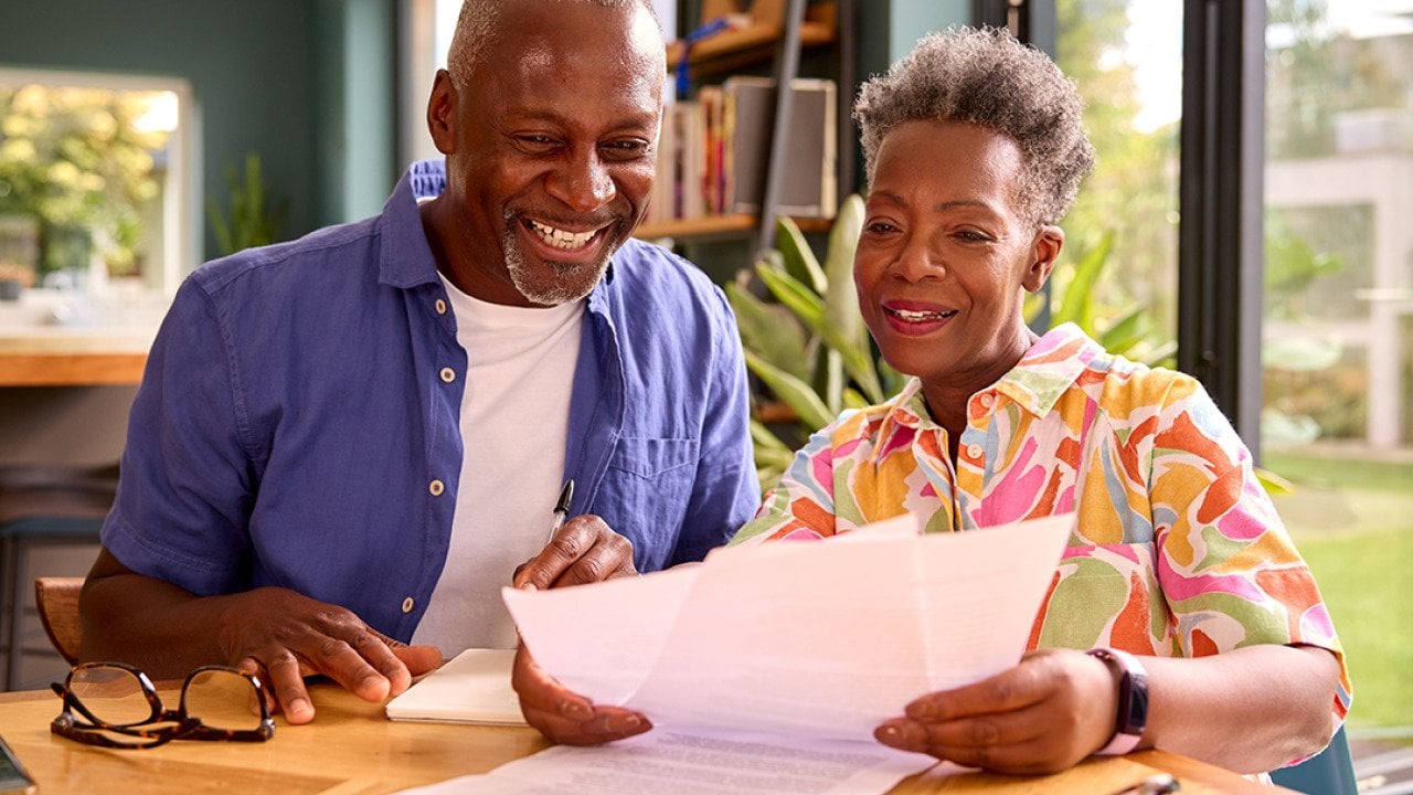 Senior couple at home reviewing finances.