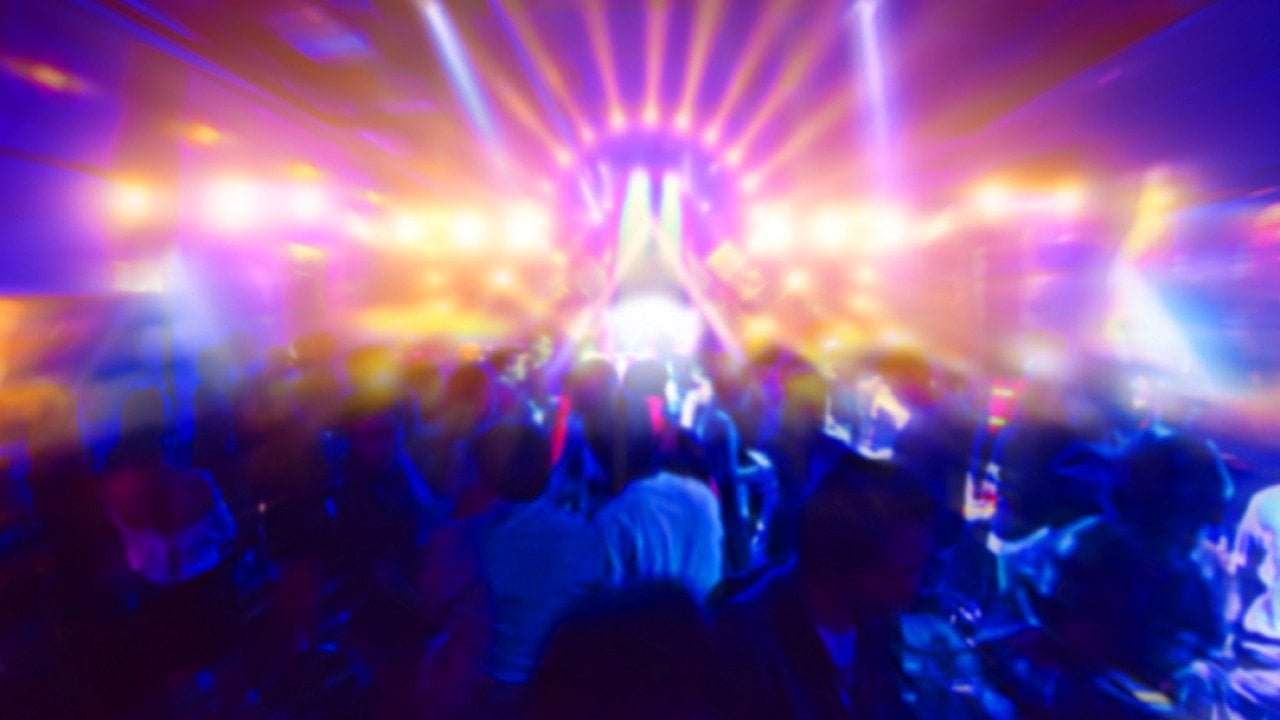Concert crowd in front of bright stage lights.