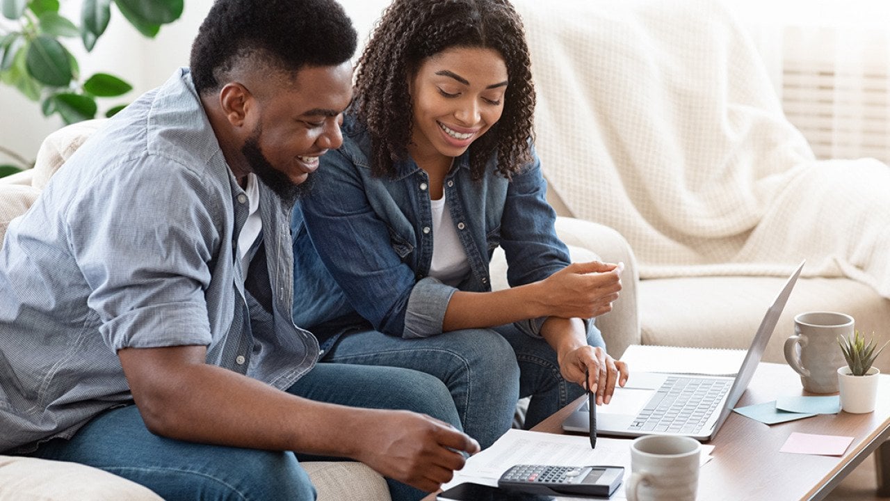 A black couple engaged in a discussion about finances.