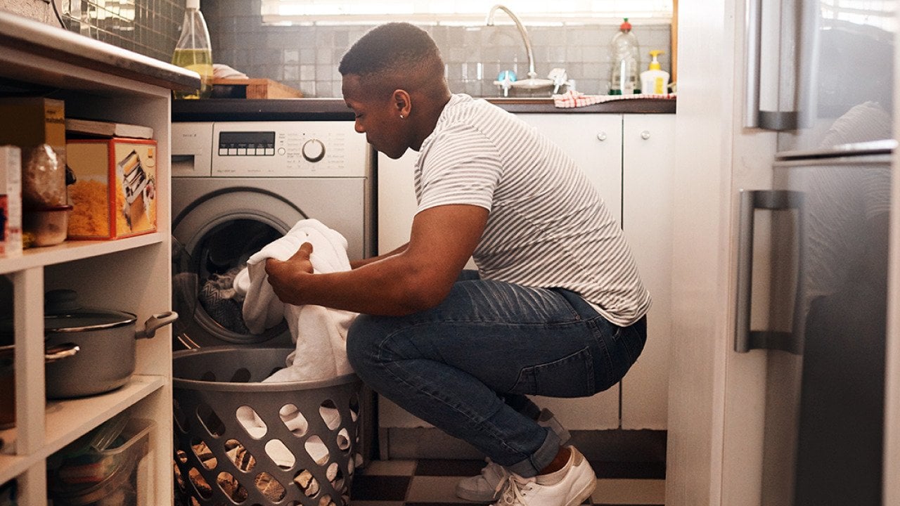 Man doing laundry at home.