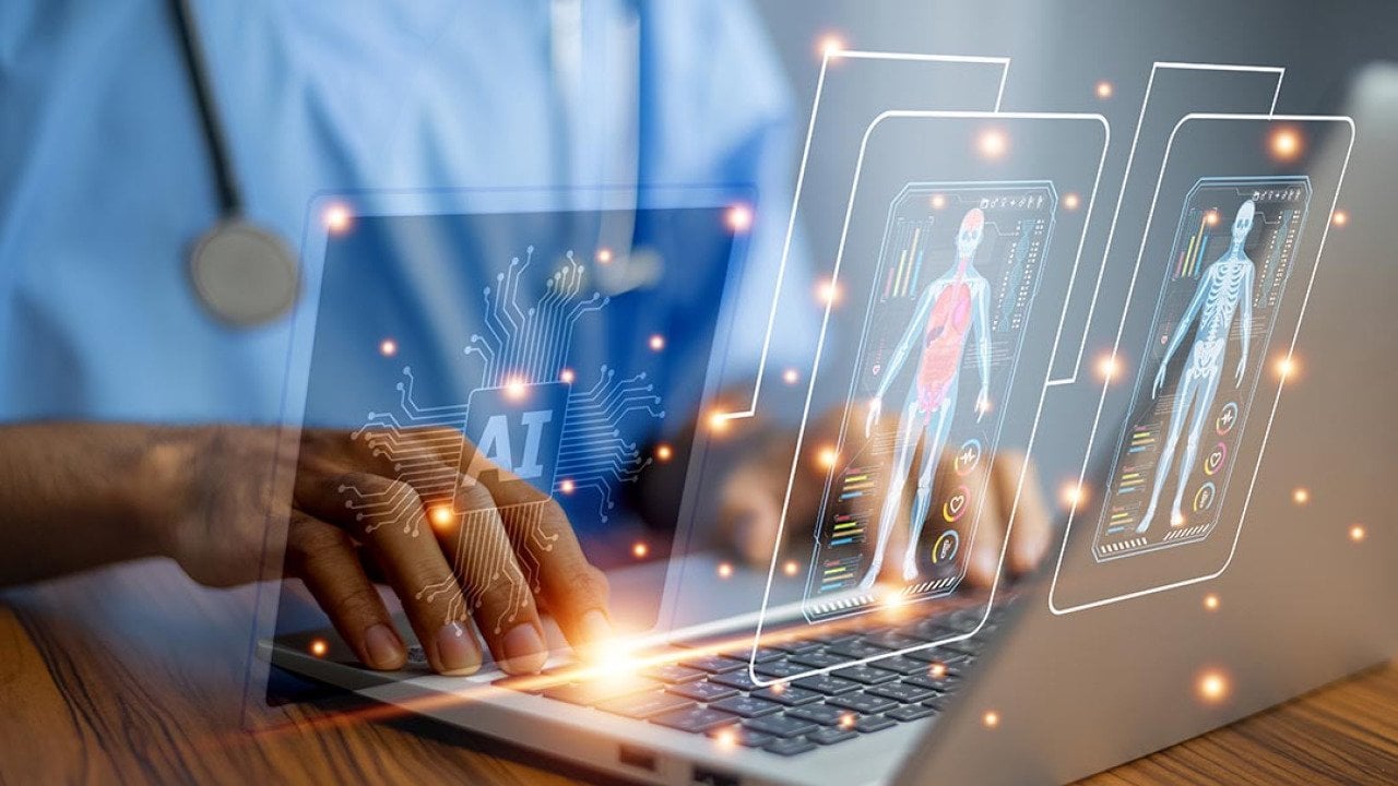 Medical professional using laptop with images symbolizing the use of AI overlaid on top.