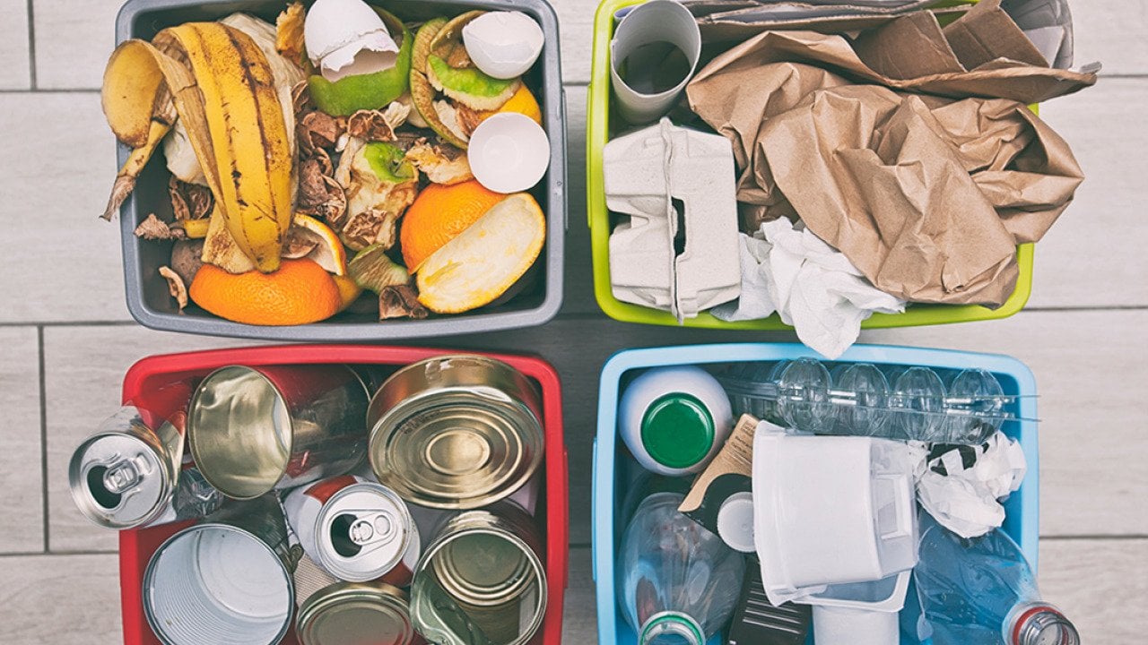 Four different container for sorting garbage for plastic, paper, metal and organic waste