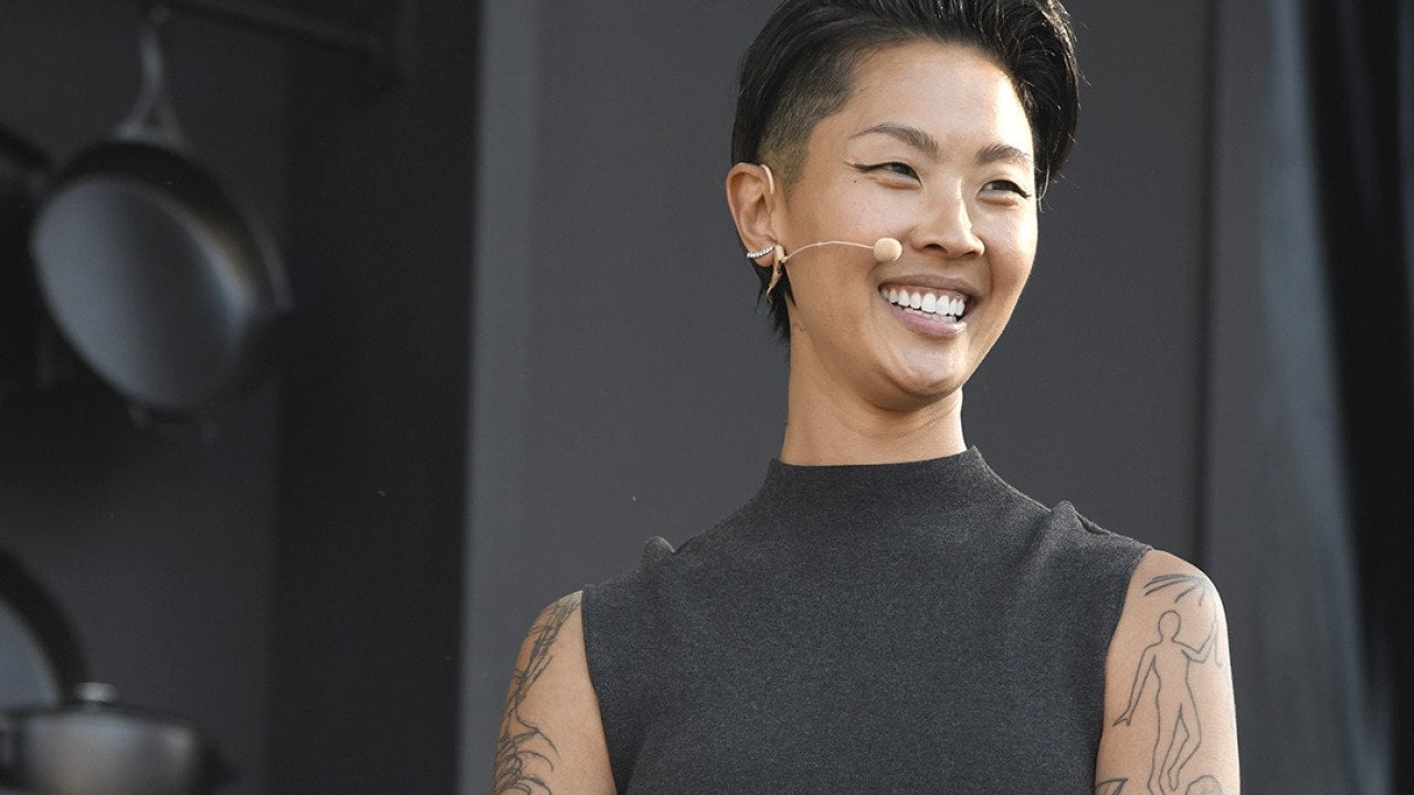Chef Kristen Kish, wearing a black sleeveless mock turtleneck and mic headset speaks at a culinary demonstration during the 2025 Bottle Rock Napa Valley festival.