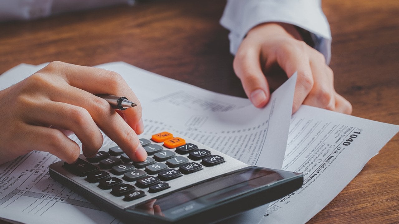 Business person calculating taxes.