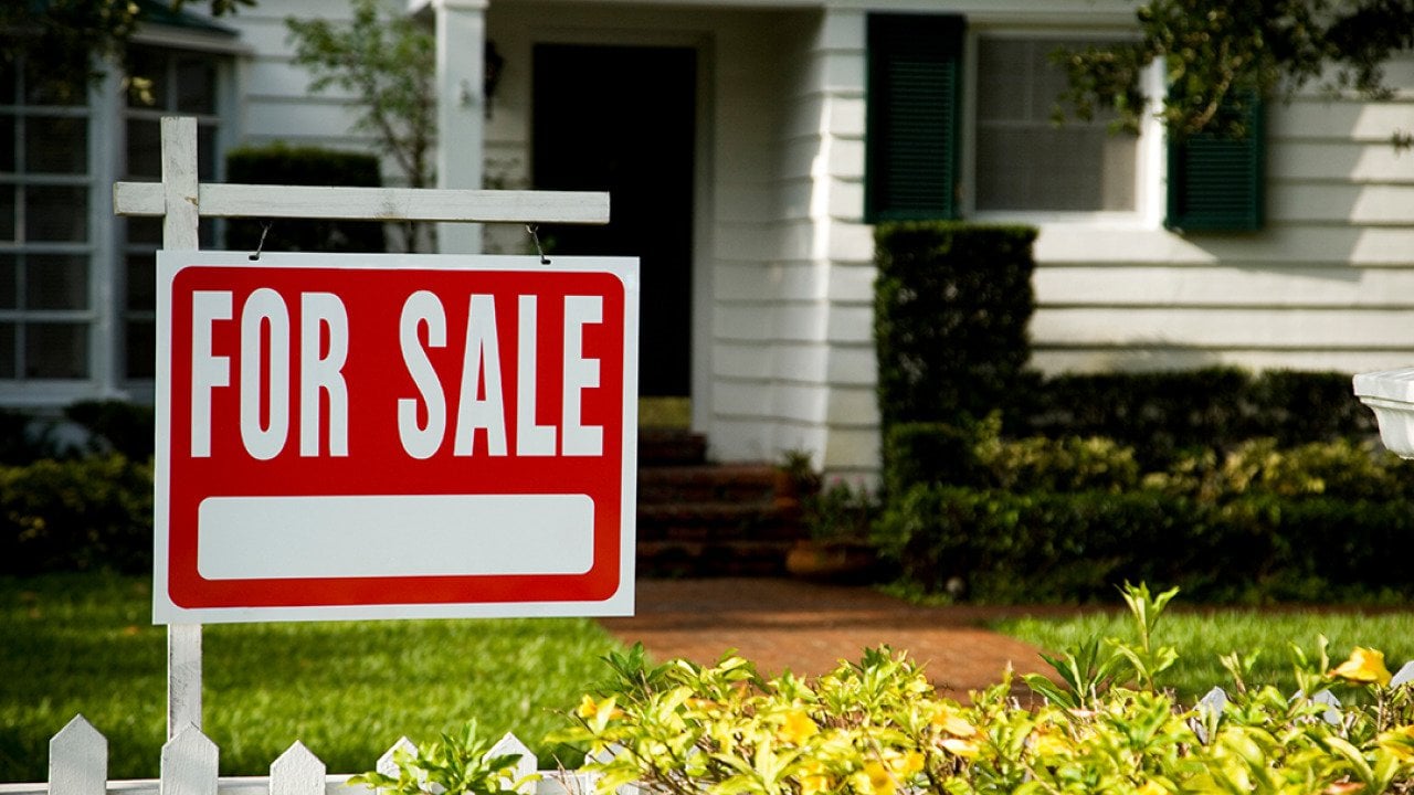 For sale sign in front of a house.