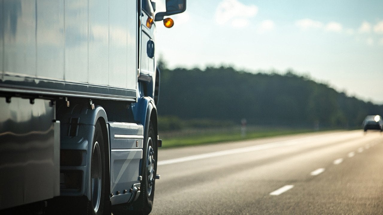 Long moving truck on a highway.