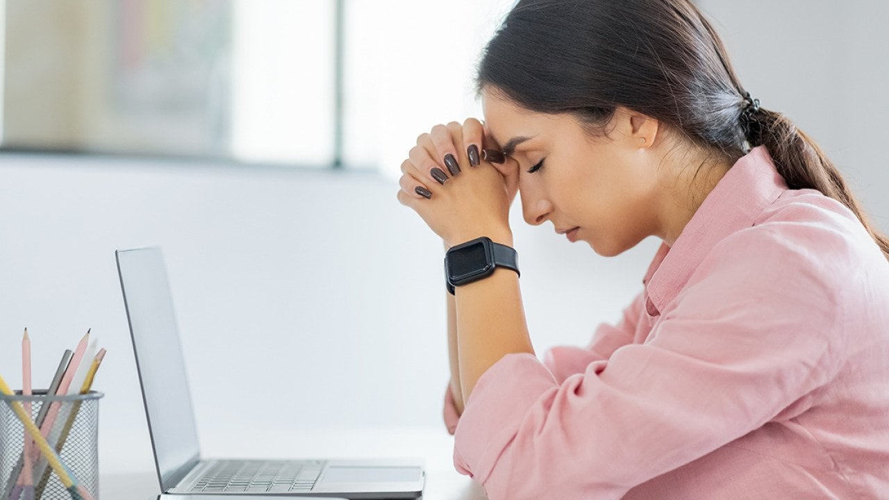 Young professional having a headache at work.