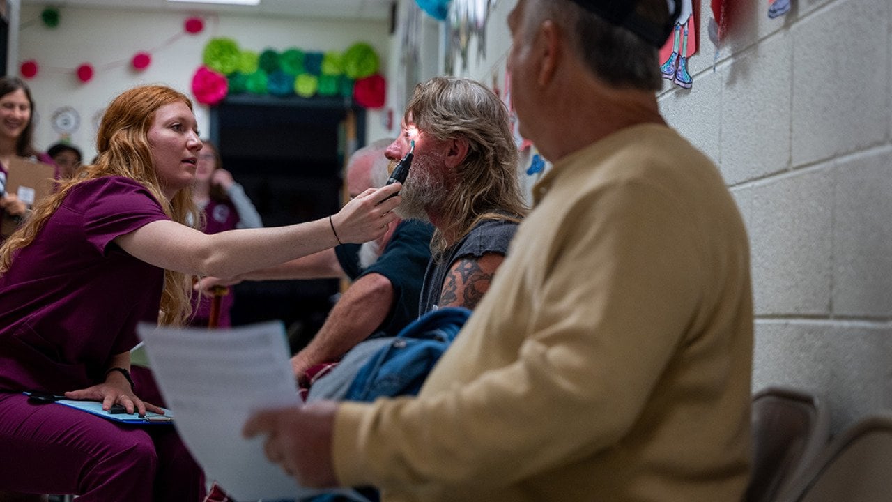  Optometry students administer vision tests to patients at a mobile dental and medical clinic in Grundy, Virginia.