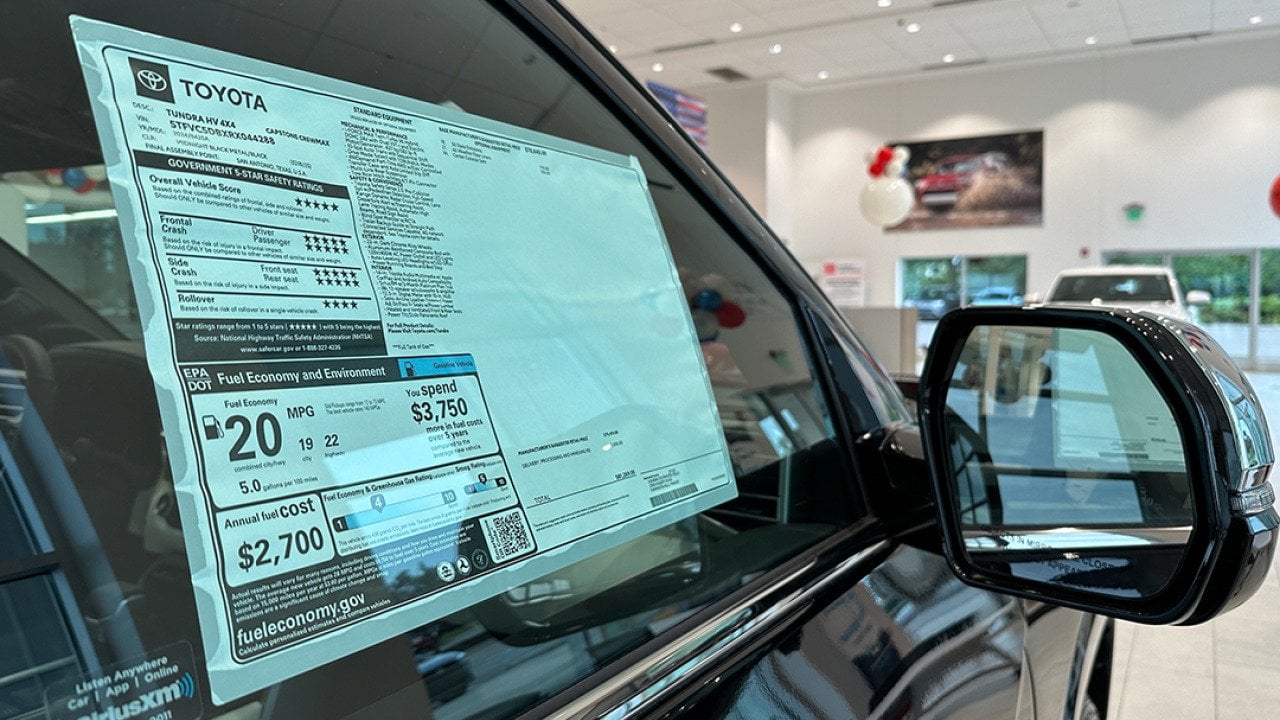 A car dealer's pricing sticker on a Toyota Tundra vehicle.