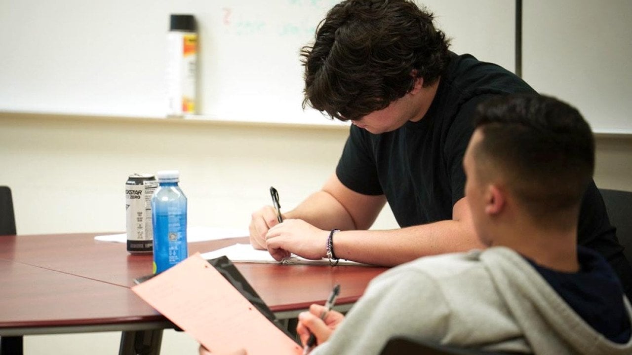 Students take notes during Dr. Adam Kaiserman's English class at College of the Canyons in Santa Clarita.