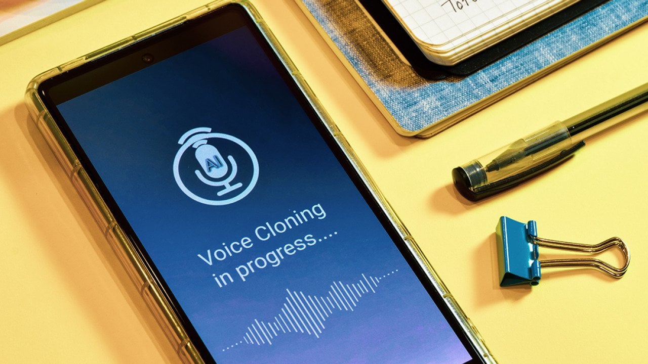 'Voice cloning in progress' displayed on a smartphone.