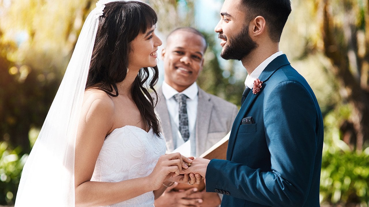 Happy couple exchanging vows during their wedding ceremony.