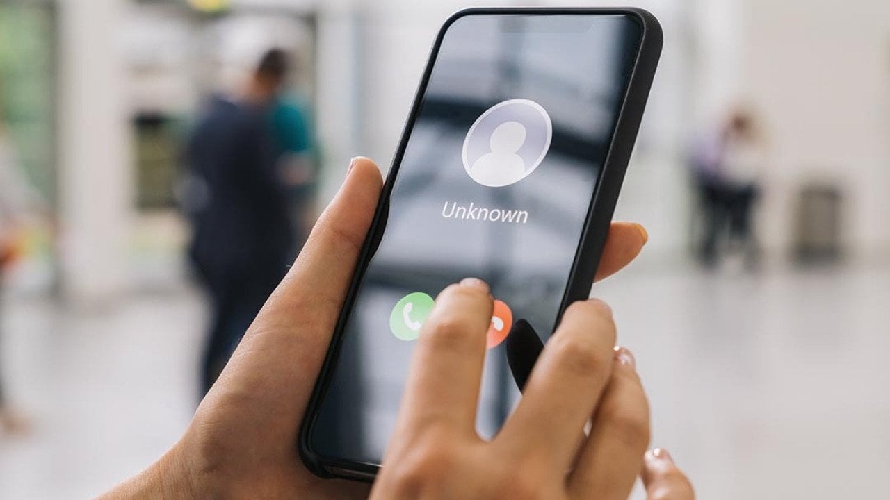 Person holding a cell phone.