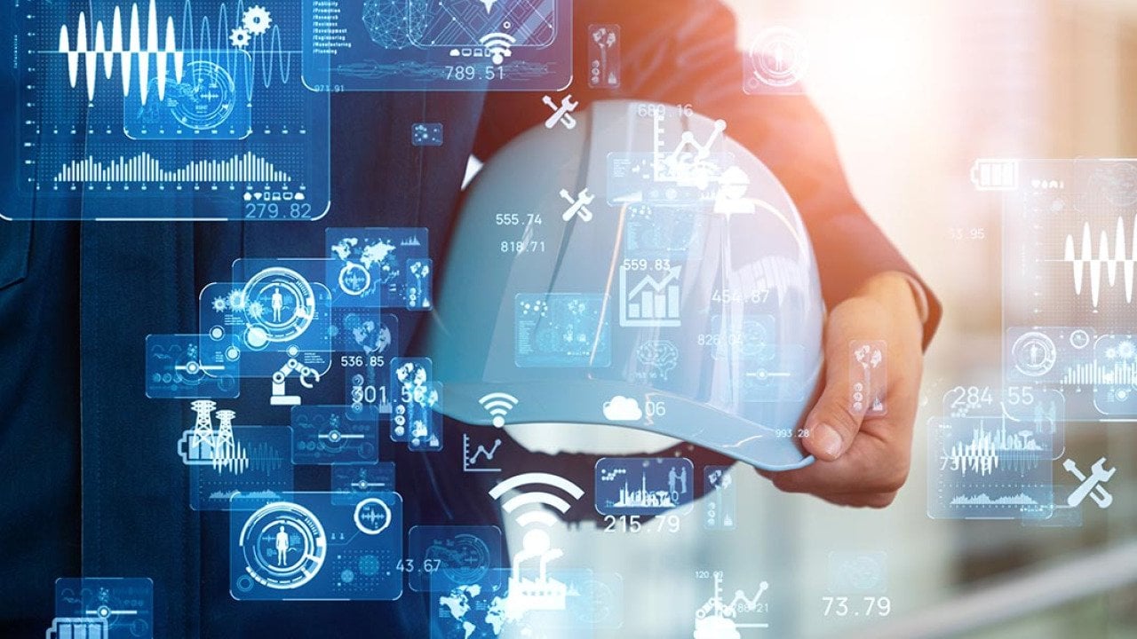 White hard hat held in the crook of a person's arm with technology icons superimposed symbolizing AI advance and sautomation of manufacturing processes using computers and electronics.