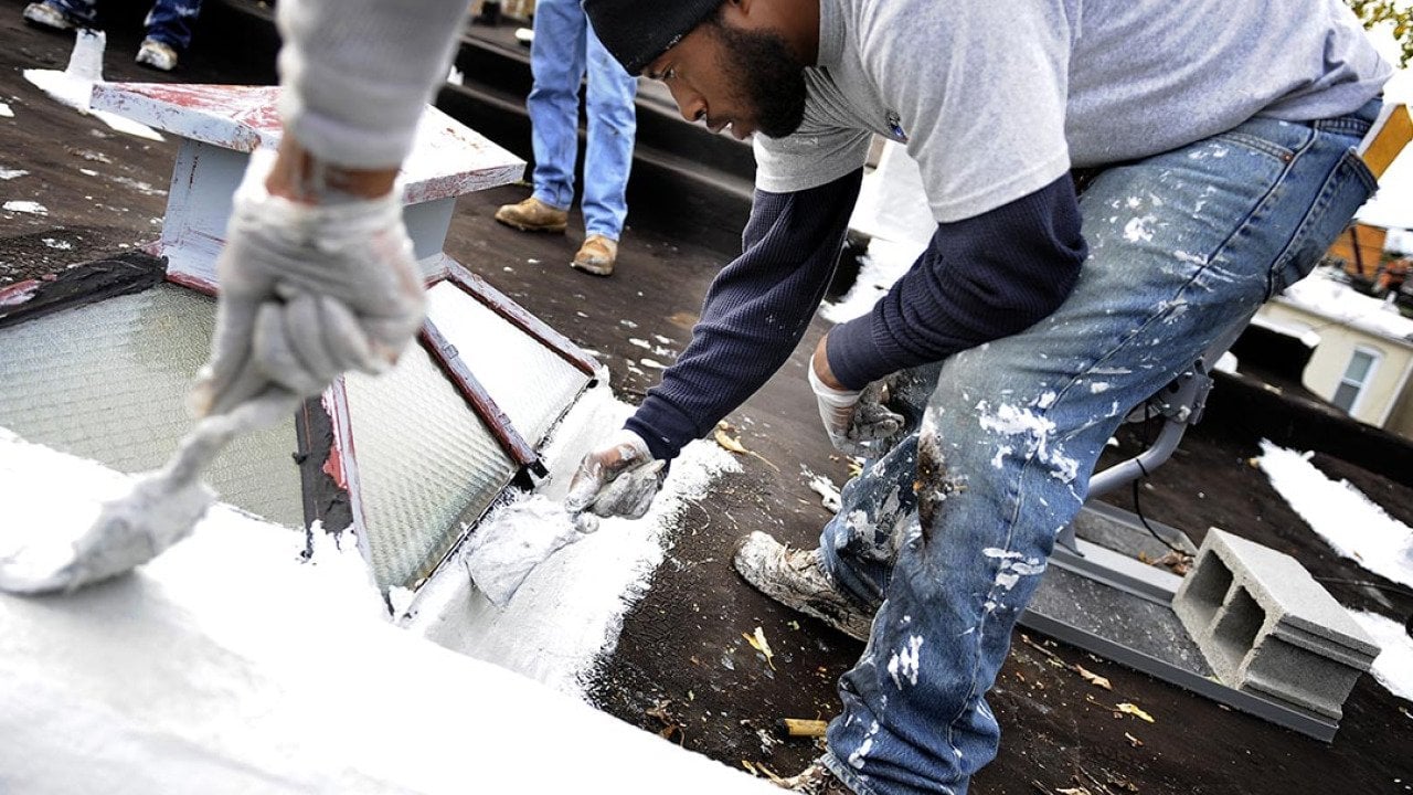 Karim Peoples help to make preparations to make it a cool roof in Baltimore.