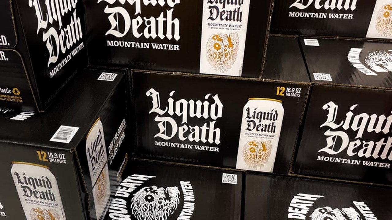 Black boxes of Liquid Death canned mountain water grocery store display.