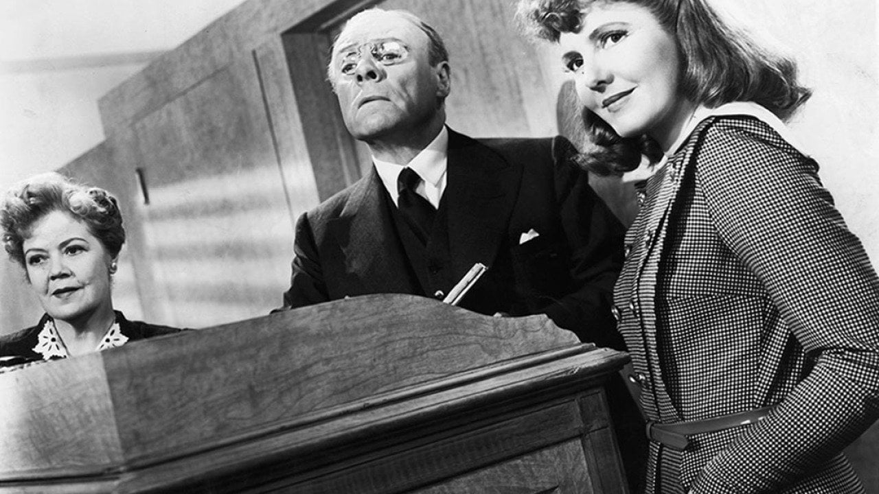 Black and white image of Spring Byington, unidentified man, and Jean Arthur in a scene from the film 'The Devil And Miss Jones', 1941. 