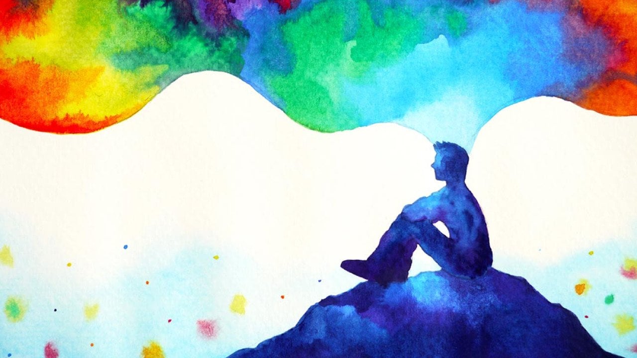 Abstract art watercolor painting illustration of person sitting on a hill with thoughts depicted in rainbow clouds floating above.