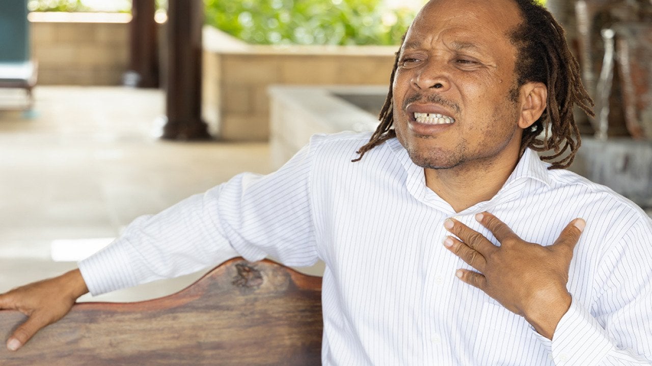 A middle-aged man suffering from acid reflux.