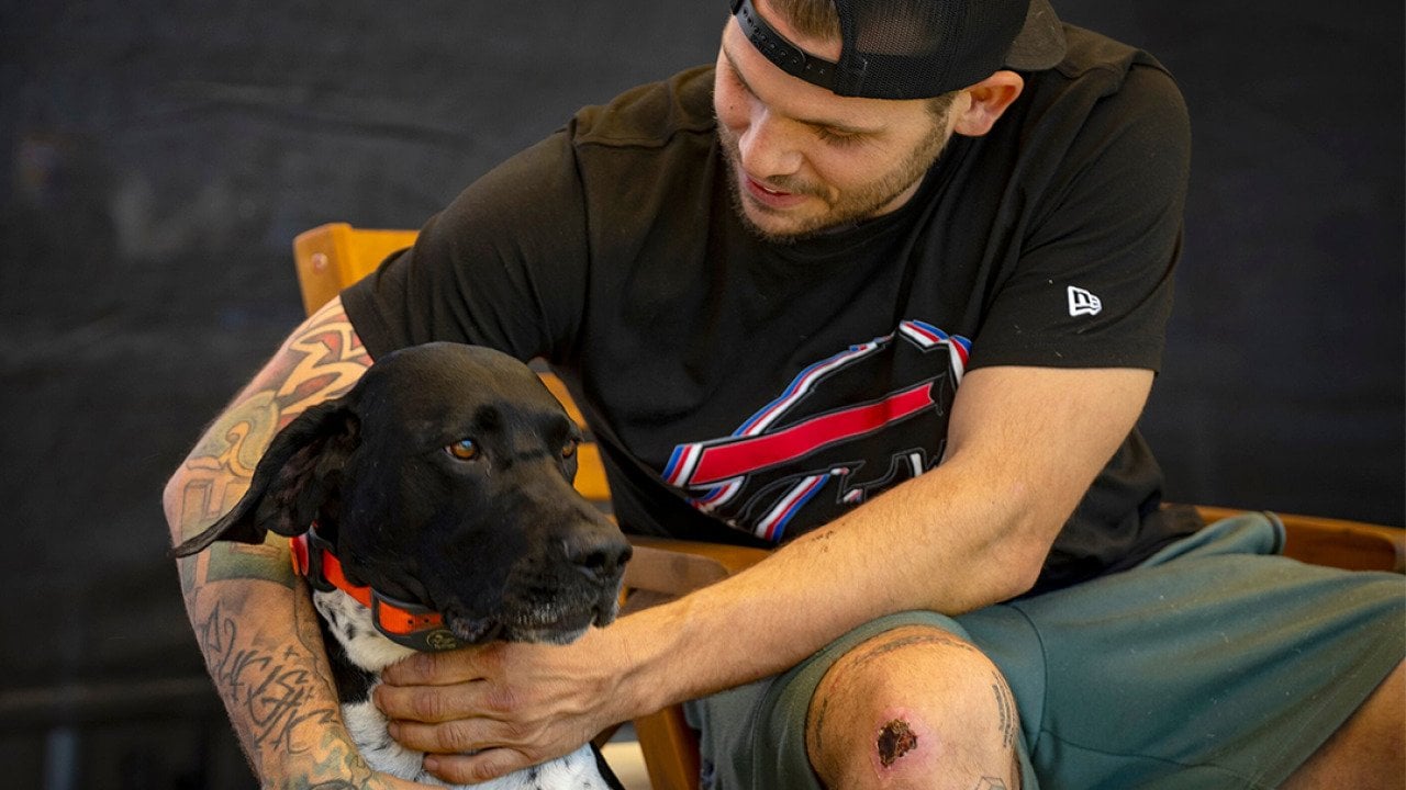Jacob Schmitt with his dog Buddy, at his home in Ogden, on Thursday, July 31, 2025.