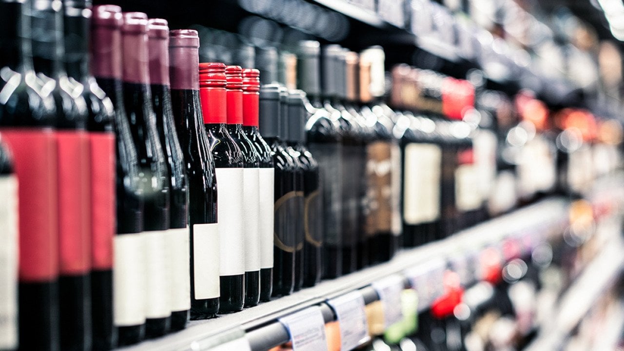 Bottles of wine on a shelf in a liquor store.