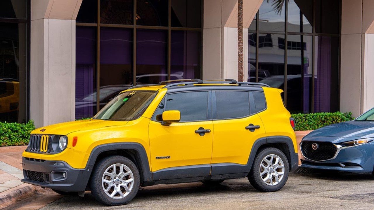 Yellow Jeep Renegade SUV parked in FL.