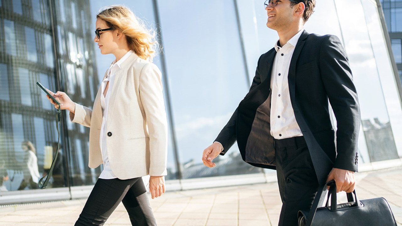 Two business professionals on the way to their work.