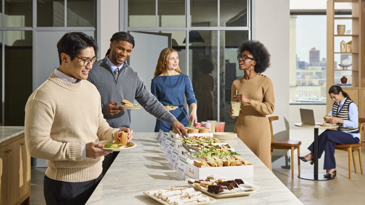 Office workers enjoying a catered lunch