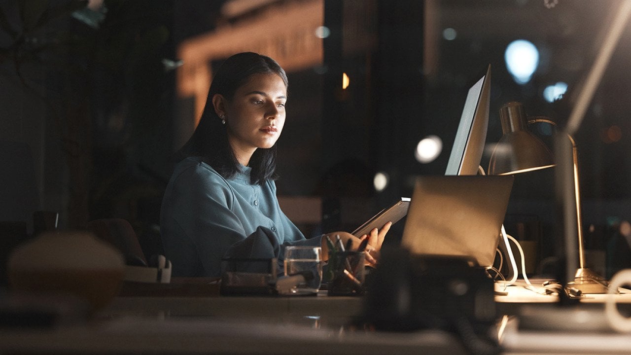 A businesswoman working in office at night.