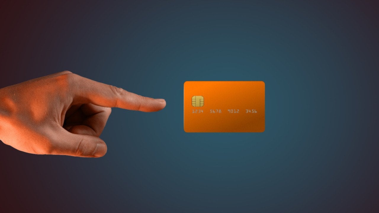 A hand levitating a credit card.