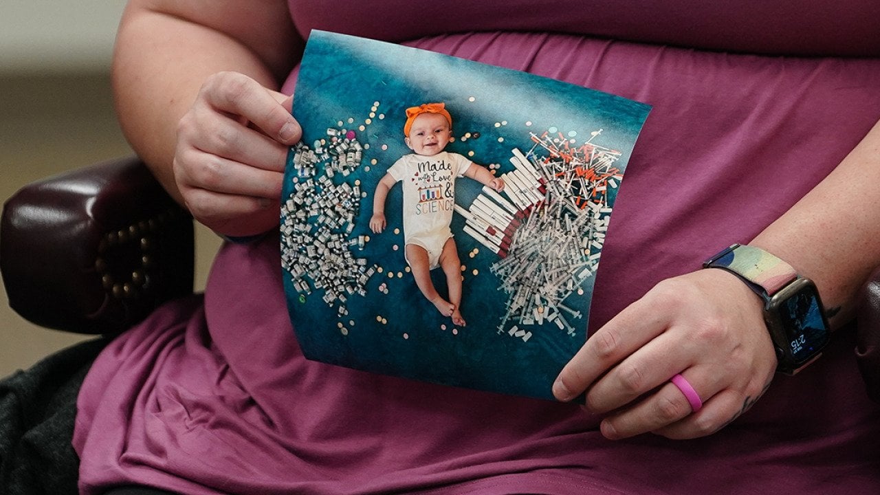 Elizabeth Goldman, an in-vitro fertilization patient at the University of Alabama at Birmingham, holds up a photo of her daughter who was born via the procedure.
