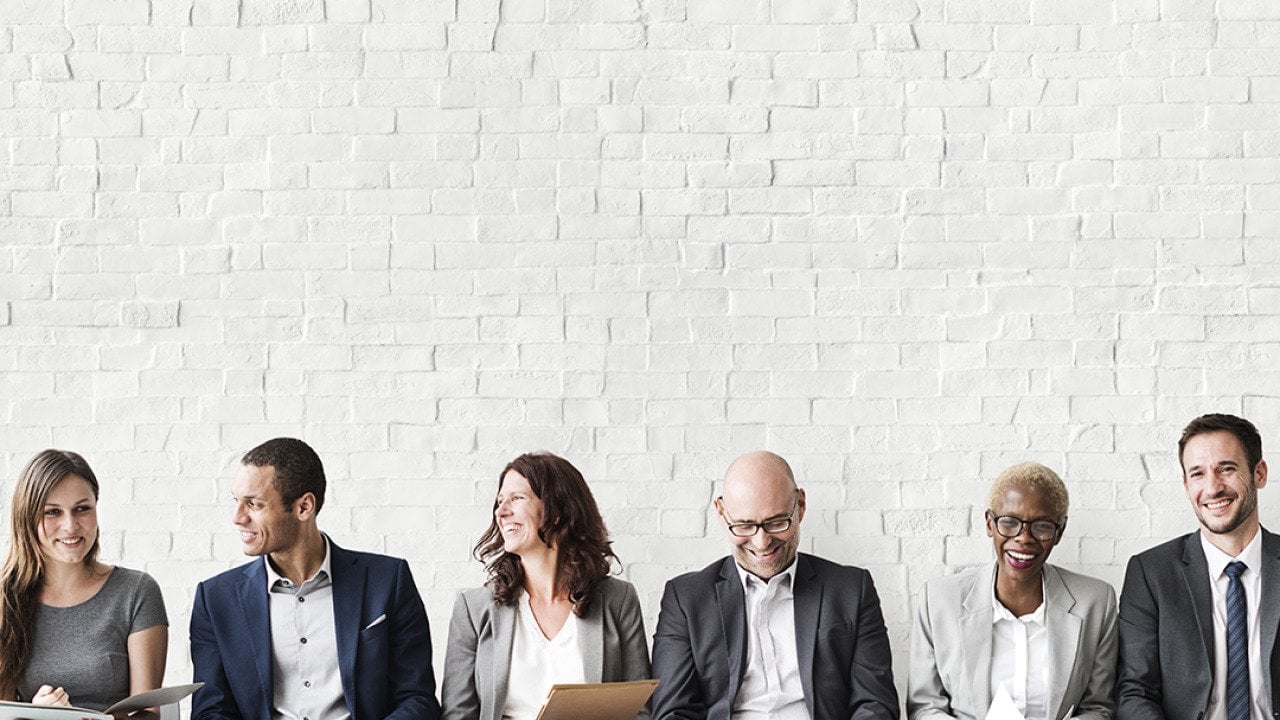 Professionals lined up sitting for a job interview.