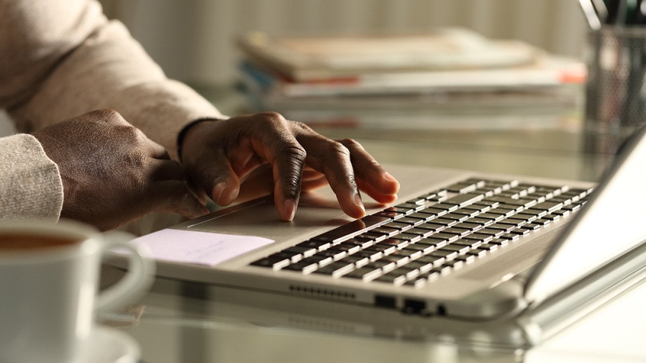 Close-up of a businessman using a laptop in the office at night.