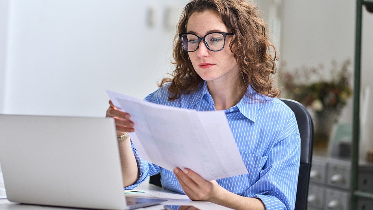 A young businesswoman reading audit reports.