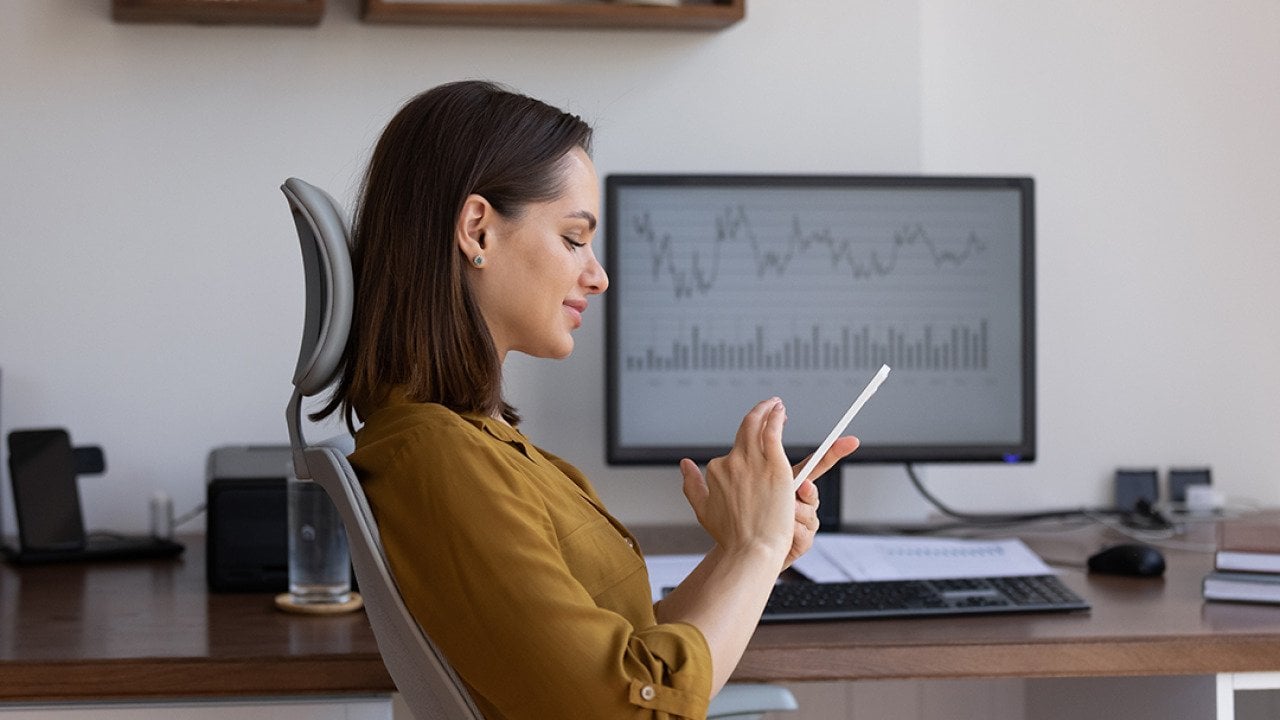A female finance woman using her smartphone at work.