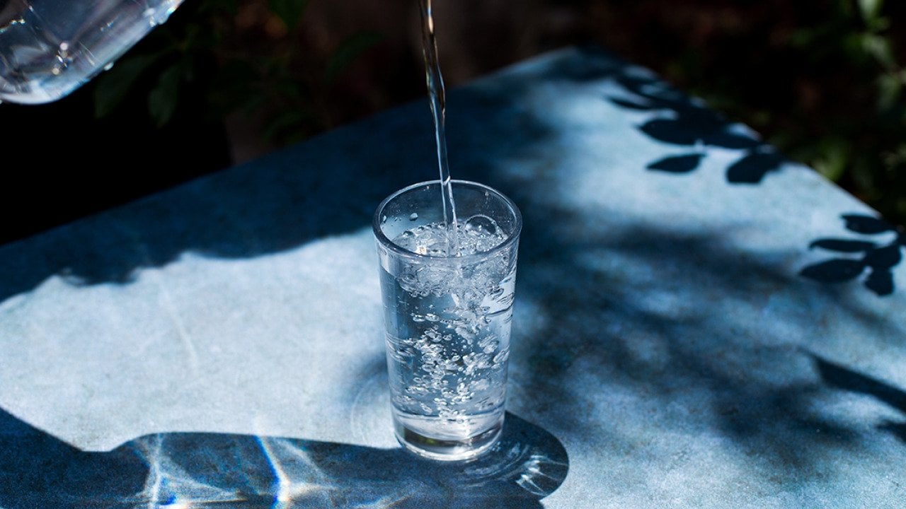 Water being poured onto a glass.