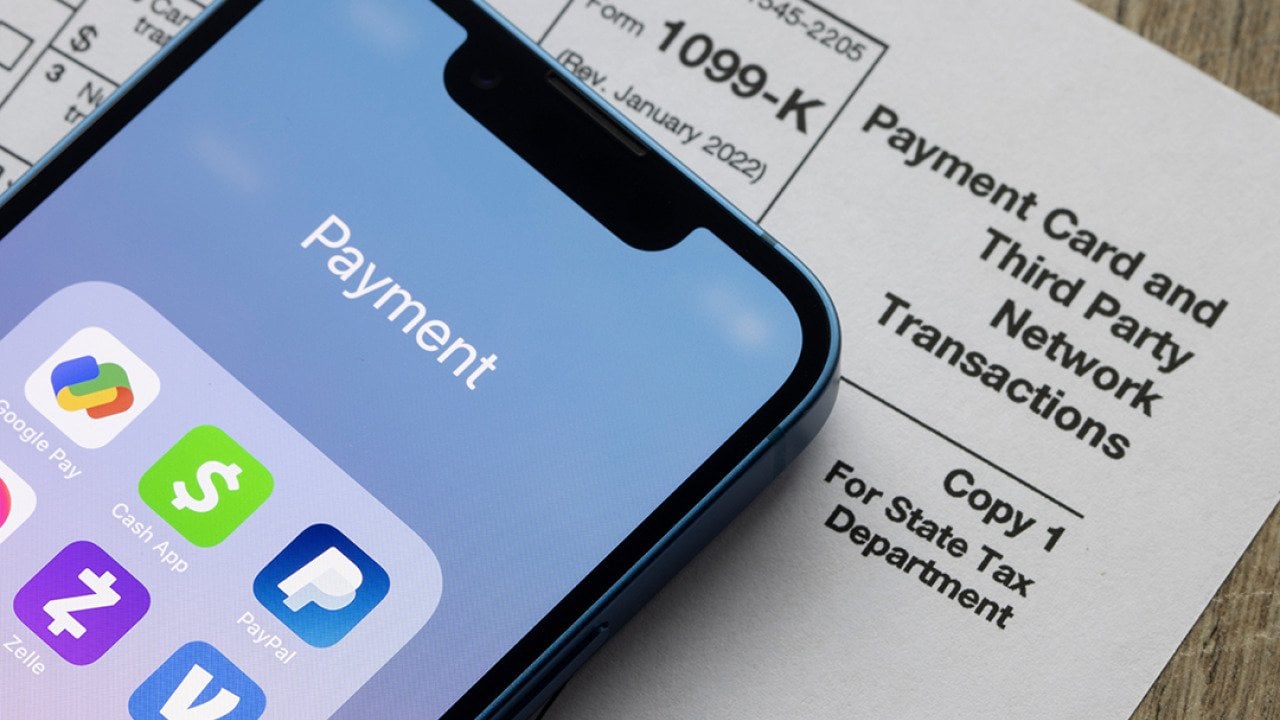 Payment apps on an iPhone and a Form 1099-K document.