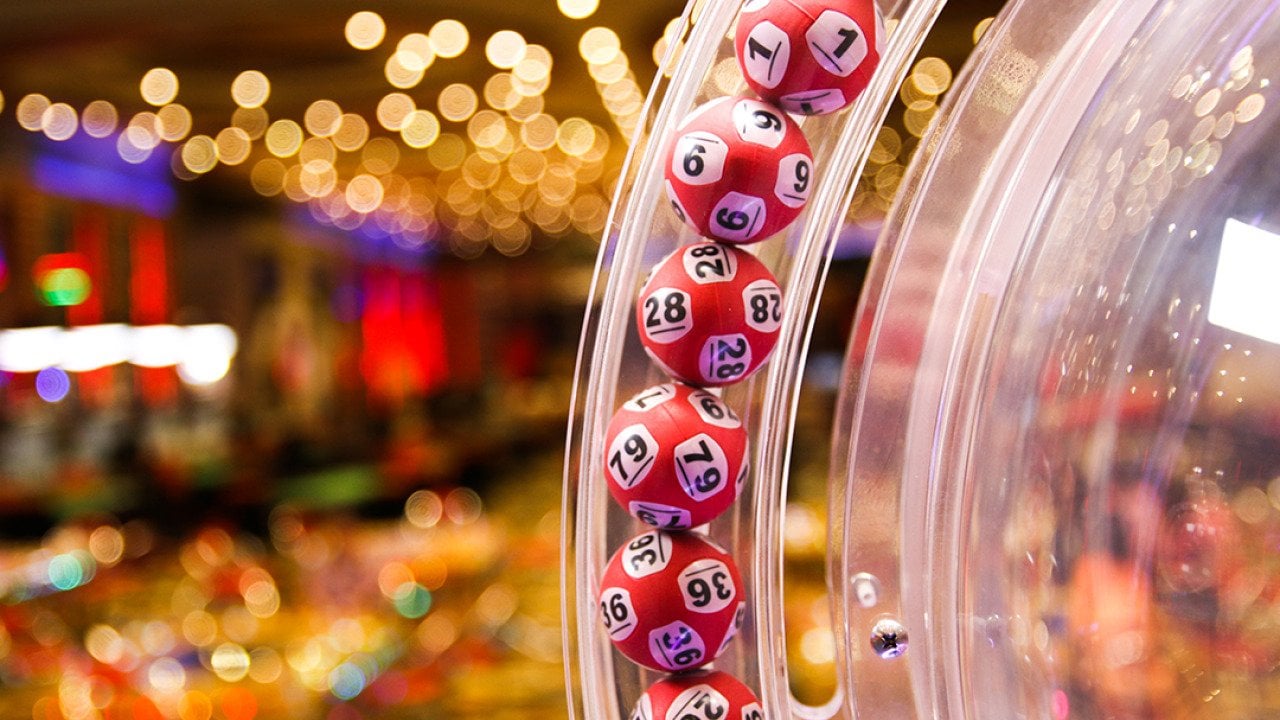 Red lottery balls in a bingo machine in a casino.