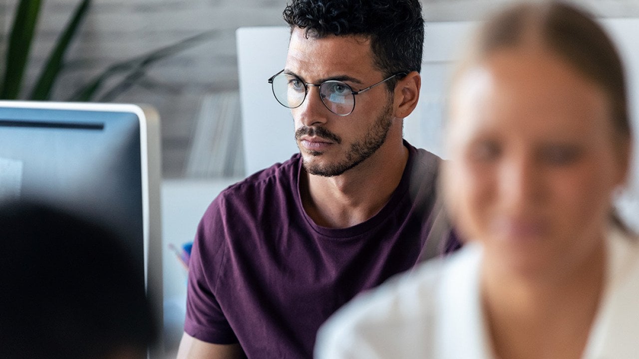 Focus shot on a young male entrepreneur working in an office.