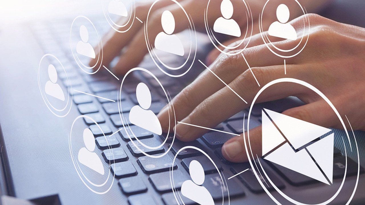 Hands typing on a keyboard illustrated with email and figure icons.