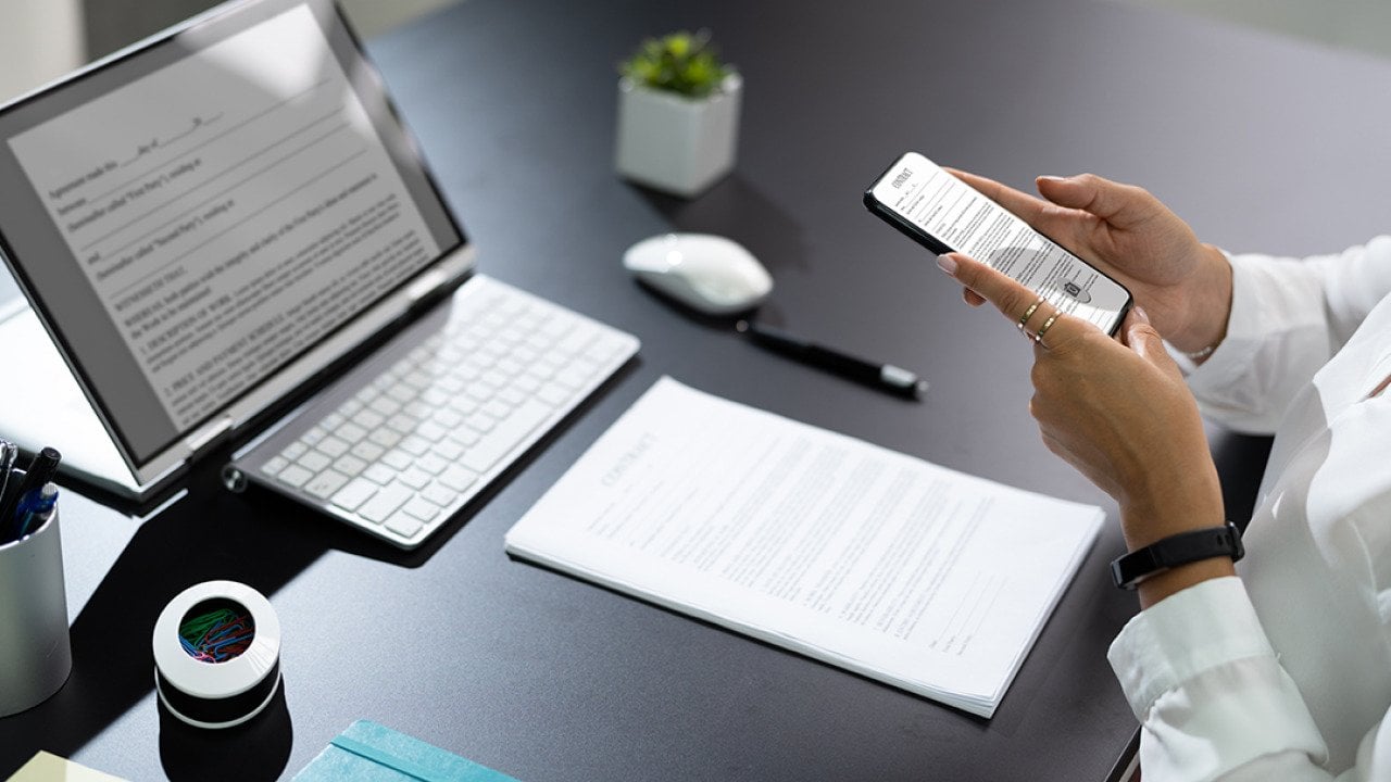 Employee at work manually scanning a document with a phone.
