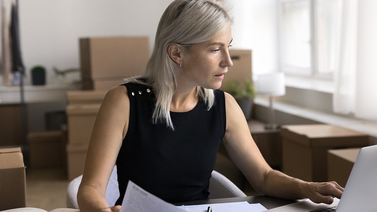 A female business owner reviewing documents in her office.