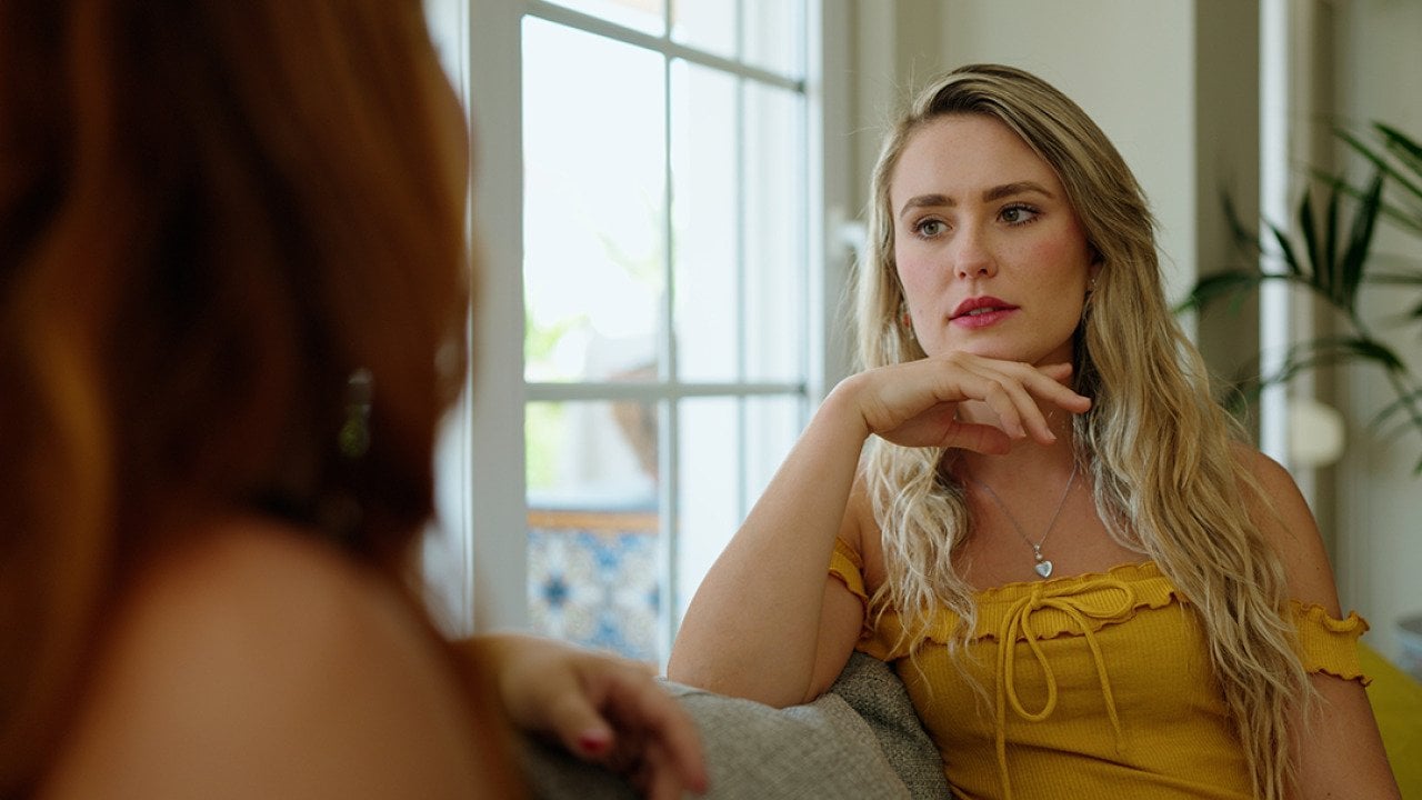 A woman talking to her friend at home.