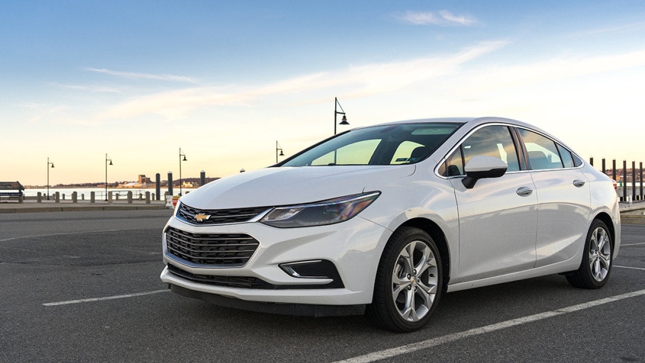 A white 2017 Chevrolet Cruz on a parking lot near seaside.