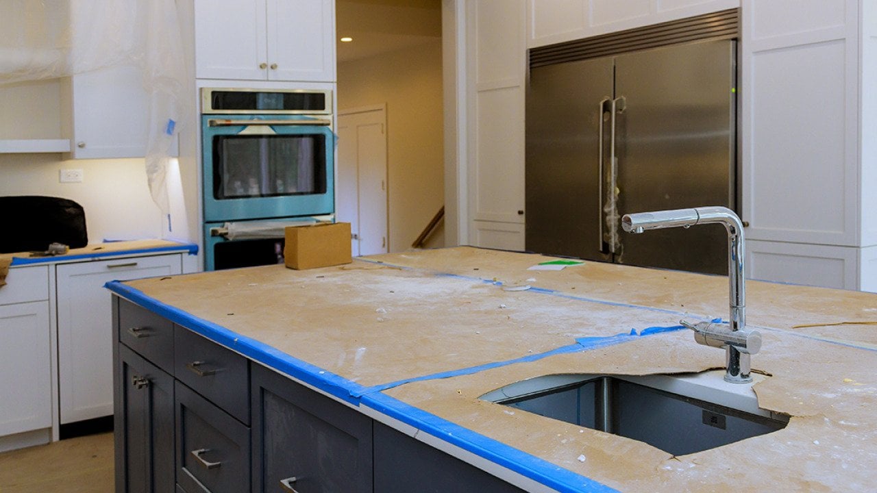 A modern kitchen with a focus on a countertop in progress of renovation.