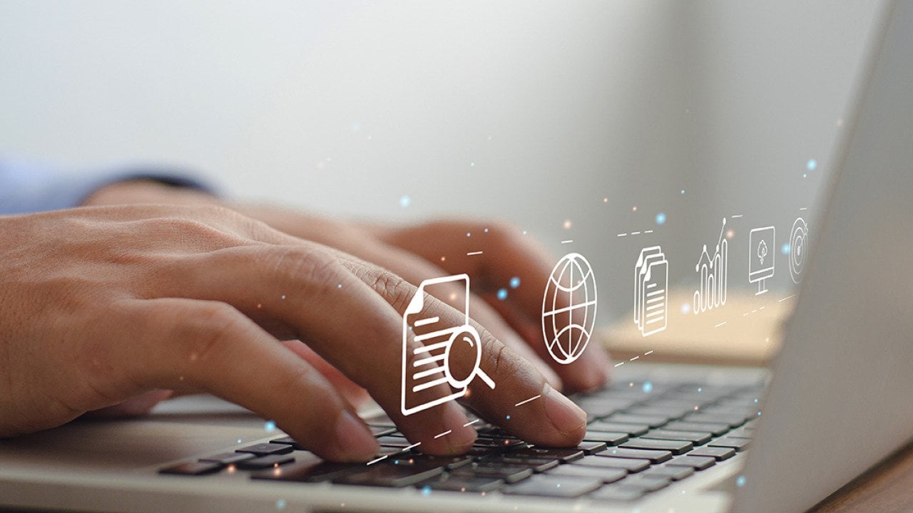Content marketing graphics over hands typing on a laptop keyboard.