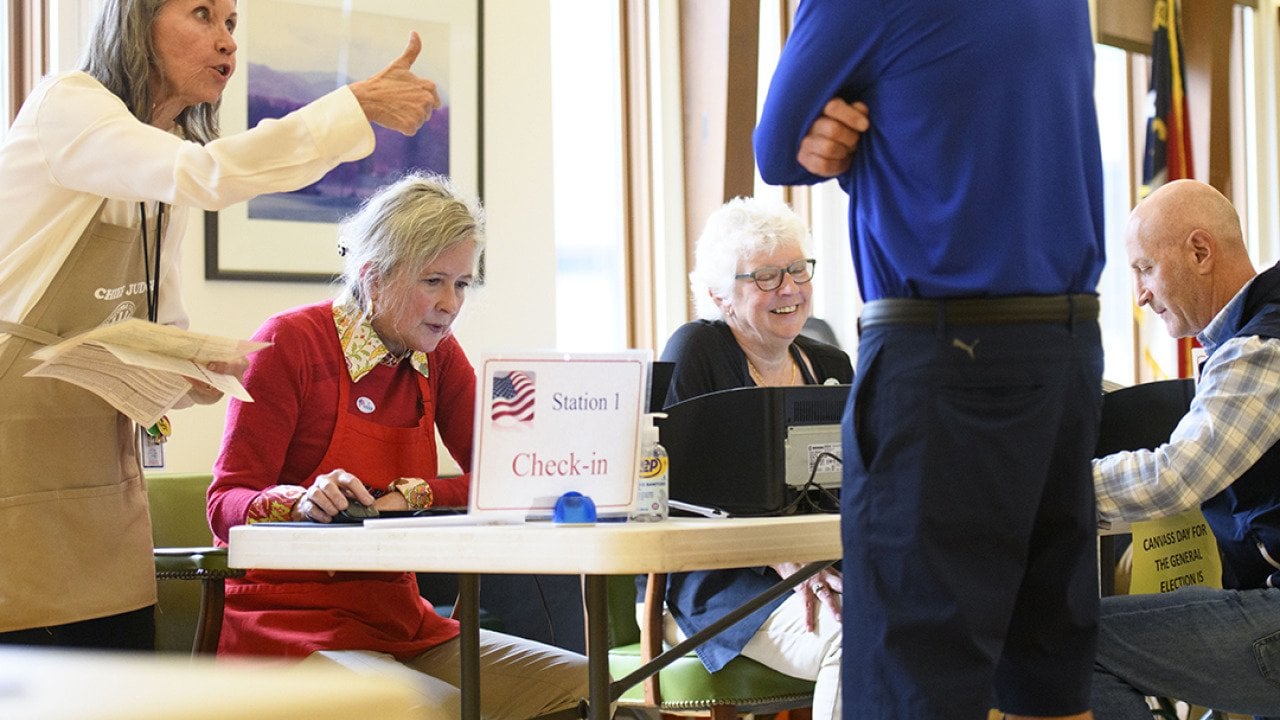 A voter receives a thumbs up from a poll worker after a successful check in at Biltmore Forest Town Hall during the 2024 U.S. election in Asheville, North Carolina. 