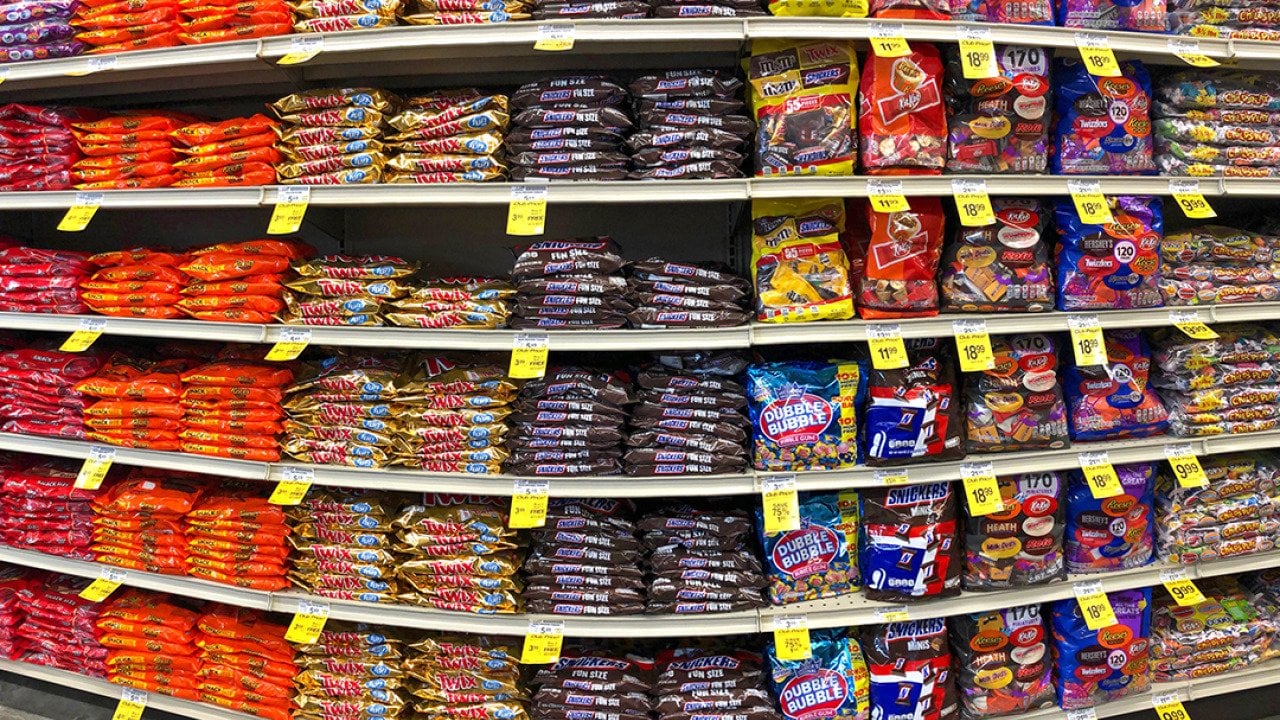 Halloween candies in grocery store shelves.