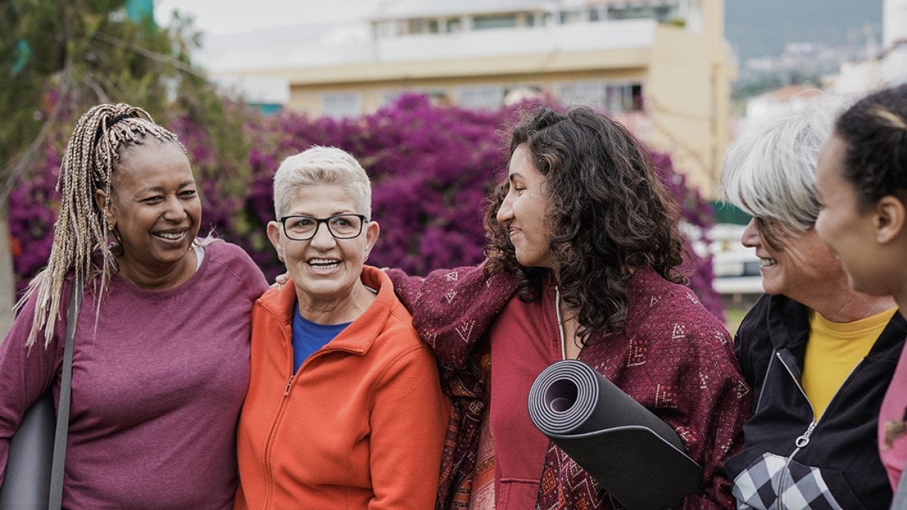 A group of four multigenerational women after a yoga class.