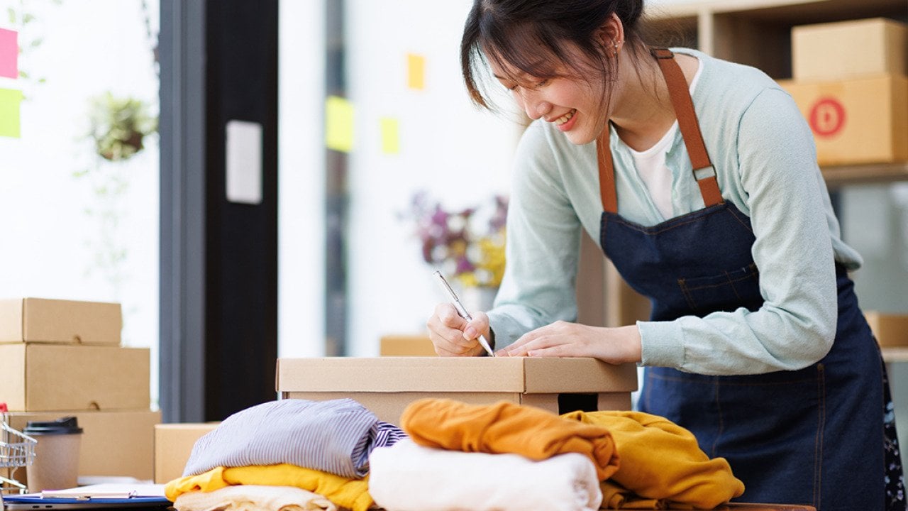 A young female small business owner preparing an order for packaging.